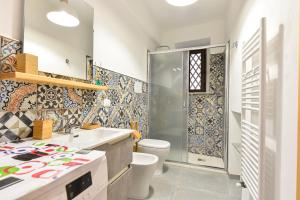 a bathroom with a shower and a toilet and a sink at Home Holiday Casanica in Agrigento +17 photos