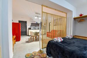 a bedroom with a bed and a living room at Home Holiday Casanica in Agrigento