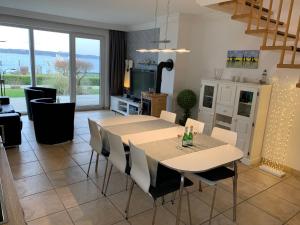 a dining room with a table and chairs at Fischerhus mit Boot,Sauna und Kamin je Seite in Bad Kleinen