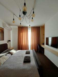a bedroom with a large bed and a television at VIGEO lounge b&b coffee in Bojnice