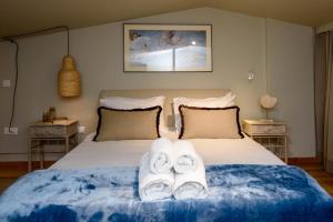 um quarto com uma cama com toalhas em "SteliosDimitra" House with view in sea of Kantia em Candia