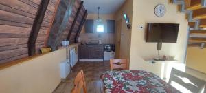 a small kitchen with a staircase in a house at Vili Bilyana in Crni Vrh