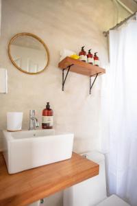 a bathroom with a sink and a mirror on the wall at The PAD at Buen Camino Bike Park in San Mateo