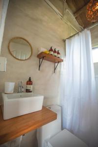 a bathroom with a sink and a mirror and a toilet at The PAD at Buen Camino Bike Park in San Mateo