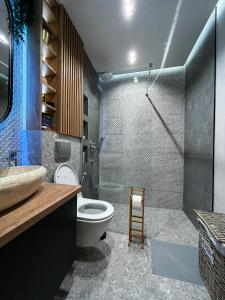 a bathroom with a shower and a toilet and a sink at Apartment Radovic in Sveti Stefan