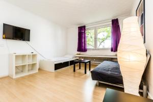 a bedroom with a bed and a window with purple curtains at WelcomeCologne Apartments in Cologne