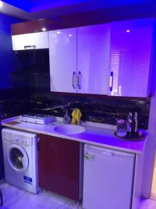 a kitchen with a sink and a washing machine at ŞİRİNYER APART OTEL in İzmir