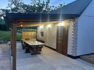 a patio with a ping pong table in front of a building at LIKe A cottage in Perušić