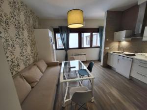 a living room with a couch and a table at Apartamentos Sol del Prior in Úbeda