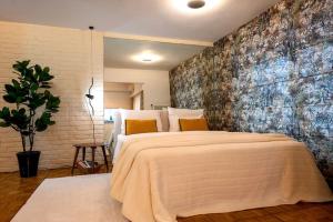 una camera da letto con un grande letto con un grande muro di Avant-Garde Studio ad Atene