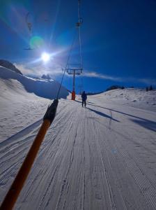 a person is skiing down a snow covered slope at Apartaments Els Avets in Pas de la Casa