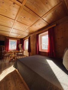 a bedroom with a bed in a wooden room at Gästehaus Hoamat'l in Bach