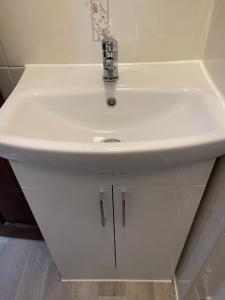 a white sink in a bathroom with at Doriam Guest House in Bridlington