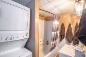 a bathroom with a toilet and a sink and a shower at The Cub Cottage in North Pole AK in North Pole +16 photos