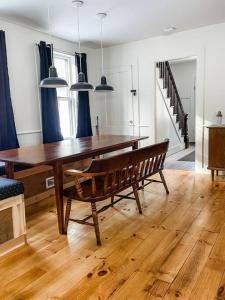 a dining room with a wooden table and a bench at The Brookside Lodge & Cottage in Dover