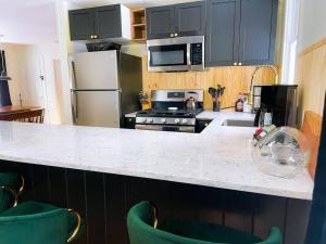 a kitchen with black cabinets and a white counter top at The Brookside Lodge & Cottage in Dover