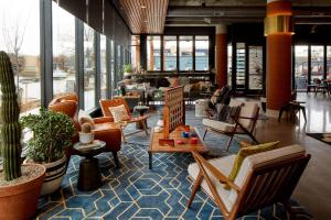 a lobby with a lot of chairs and tables at MOXY Denver Cherry Creek in Denver