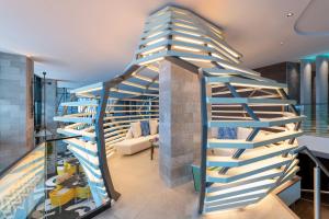 a spiral staircase in a living room at W Algarve in Albufeira