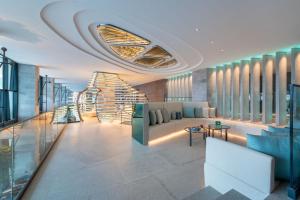 a lobby of a building with a couch and tables at W Algarve in Albufeira