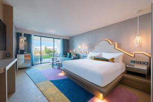 a bedroom with a large white bed in a room at W Algarve in Albufeira