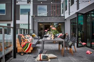 a patio with a table and chairs on a building at MOXY Denver Cherry Creek in Denver