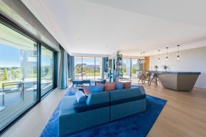 a living room with a blue couch and a table at W Algarve in Albufeira