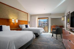 a hotel room with two beds and a television at The Westin Rancho Mirage Golf Resort & Spa in Rancho Mirage