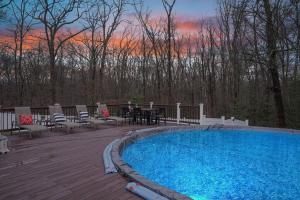 a swimming pool on a deck with a table and chairs at Beautiful Modern Farmhouse Style Mins 2 Beach, Winery, Casino, Shopping and More 