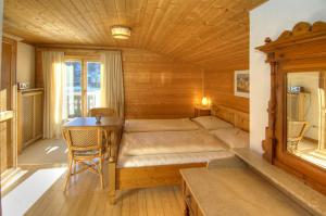 a bedroom with a bed and a desk in a room at Chalet Sonne in Maria Alm am Steinernen Meer