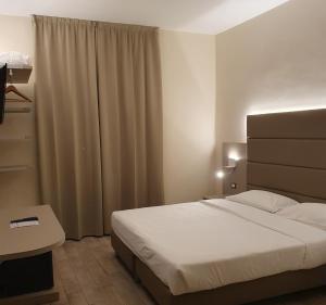 Łóżko lub łóżka w pokoju w obiekcie LH Hotel Excel Roma Montemario