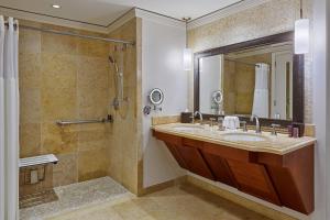 a bathroom with a sink and a shower at The Ritz-Carlton Maui, Kapalua in Lahaina
