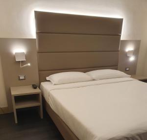 Łóżko lub łóżka w pokoju w obiekcie LH Hotel Excel Roma Montemario