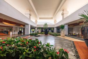 a large lobby with potted plants and flowers at Waikoloa Beach Marriott Resort & Spa in Waikoloa