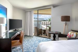 a hotel room with a bed and a flat screen tv at Waikoloa Beach Marriott Resort & Spa in Waikoloa