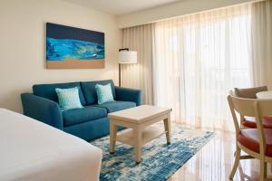 a hotel room with a blue couch and a table at Marriott Puerto Vallarta Resort & Spa in Puerto Vallarta