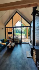 a large living room with a large glass window at Forest Garden Family 