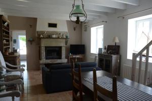 a living room with a table and a couch at Petite maison bretonne pour 4 personnes in Plounérin