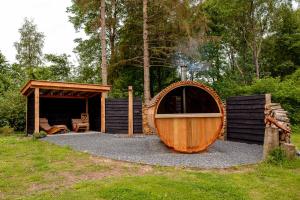 a large wooden boat sitting next to a cabin at de Grutto in Appelscha +21 photos