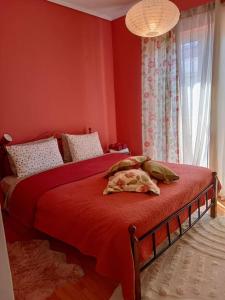 una camera rossa con due letti e una finestra di ViNCENT - Central 2 Bedroom Apartment 79sqm a Tripoli (Tripolis)