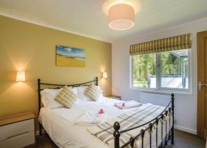 a bedroom with a large bed and a window at Woodside Coastal Retreat in Ryde