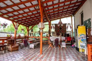 a pavilion with a table and chairs in a room at Pensiunea Larisa in Ocna Şugatag