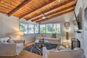 a living room with two couches and a table at Whitecaps Beach house in Delray Beach