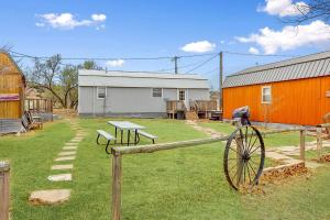 a yard with a bench and a table and a barn at Palo Duro Canyon Texas - Cowboy Cabin in Canyon