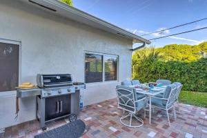 a patio with a grill and a table and chairs at Whitecaps Beach house in Delray Beach