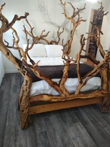 a wooden bed made out of tree branches at Location, Location middle of downtown with private parking! in Phoenix