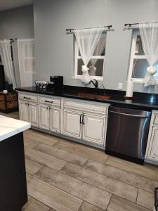 a kitchen with white cabinets and a black counter top at Location, Location middle of downtown with private parking! in Phoenix