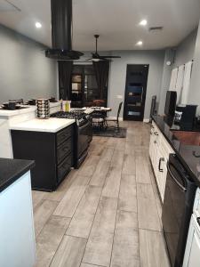 a large kitchen with white cabinets and a wooden floor at Location, Location middle of downtown with private parking! in Phoenix