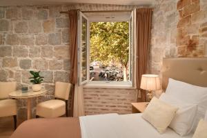 1 dormitorio con cama y ventana en Lanterna Rooms, en Split