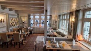 a restaurant with tables and chairs and a large window at Bio- und Wellnesshotel Alpenblick in Höchenschwand
