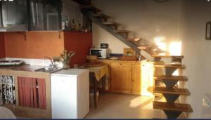 a kitchen with a sink and a staircase in a room at Romantic Casa Lorenzina Affittacamere in Ventimiglia